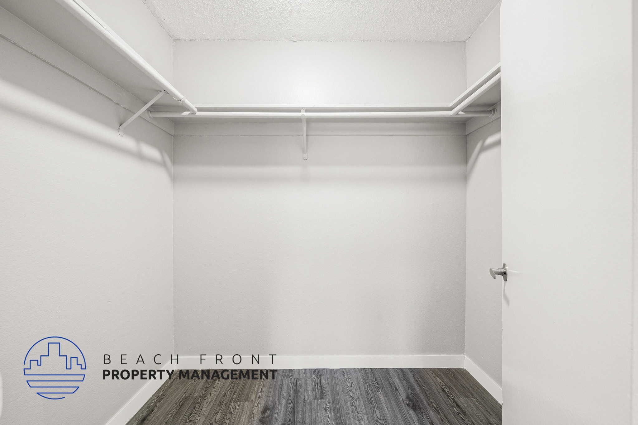 A white room with a logo for Beach Front Property Management.